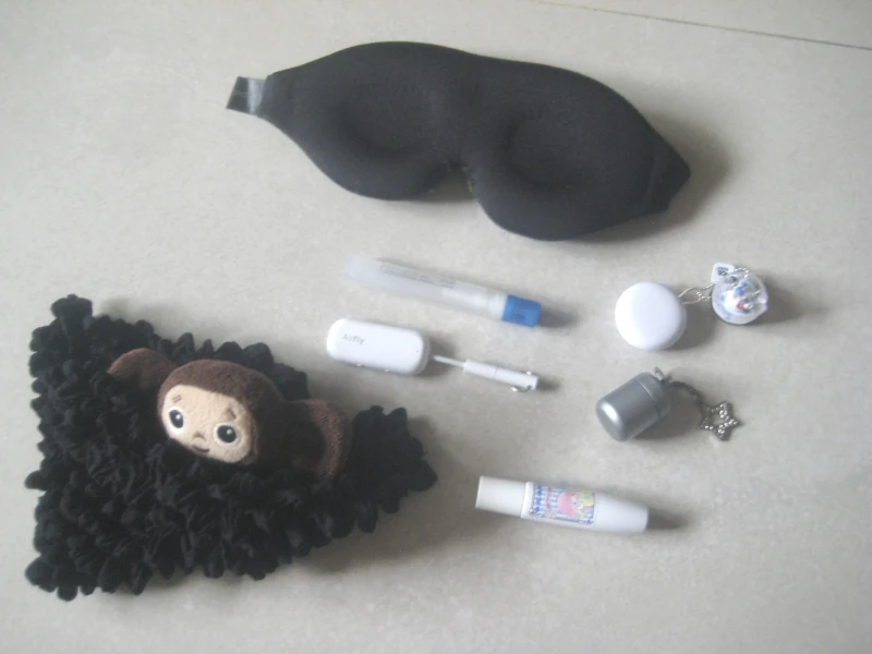 sleep mask, plush toy and small toiletries